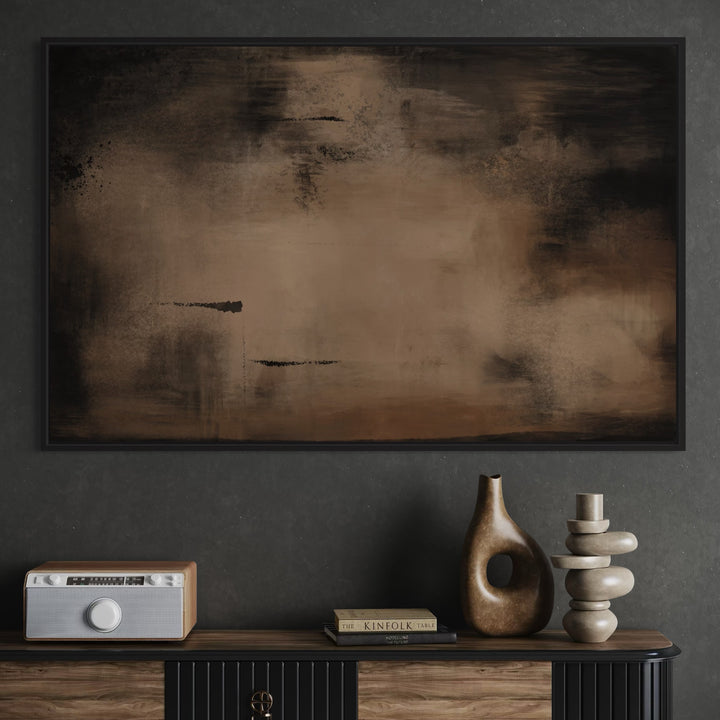 Abstract painting on a dark wall with decorative items below