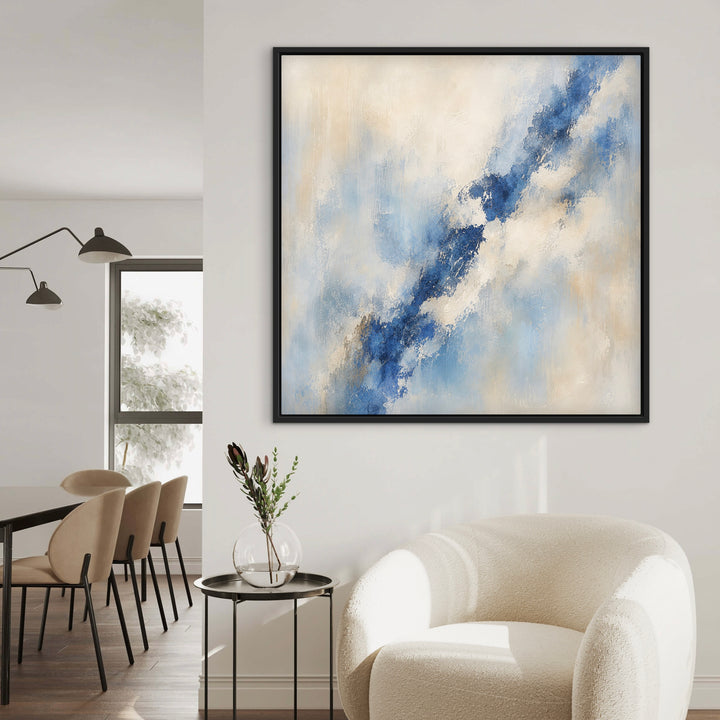 Lazuli lapis blue abstract canvas beside a cream boucle armchair