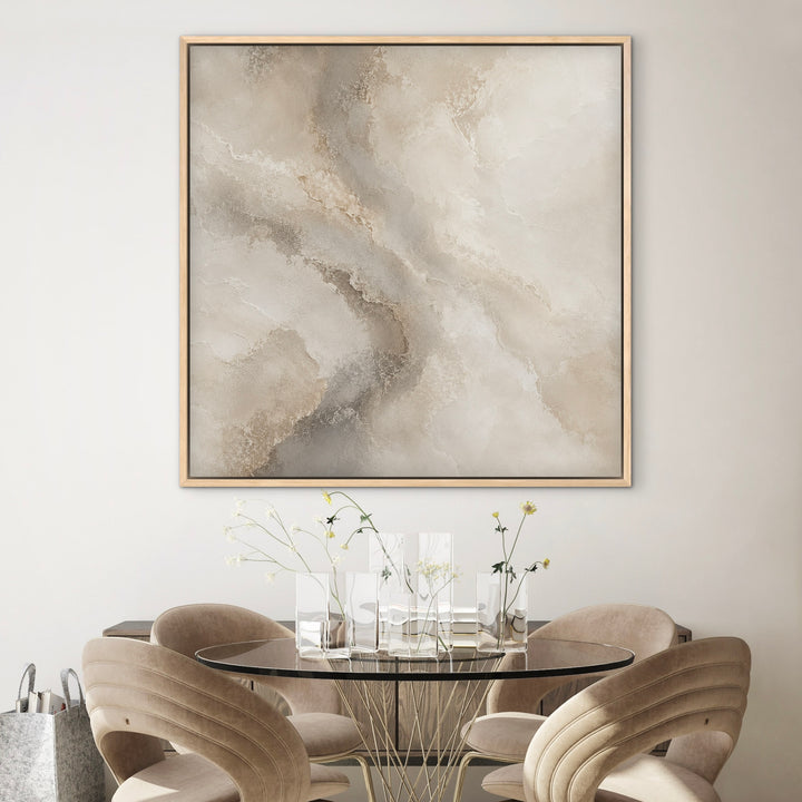 Marble Drift neutral square canvas in a gold frame above a round dining table
