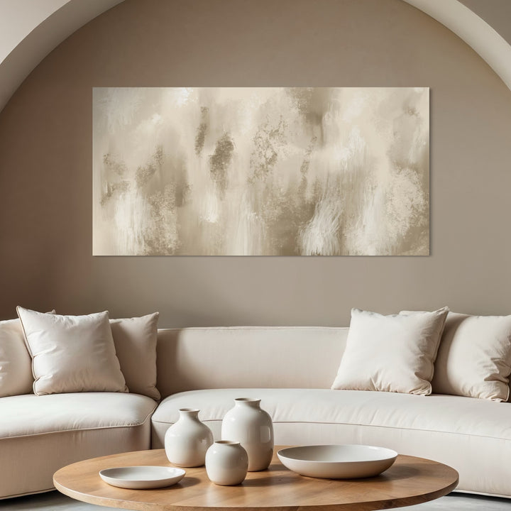 Large Neutral Abstract Canvas Wall Art paired with Cream Curved Sofa, Ceramic Vases, and Round Wood Coffee Table in a Modern Minimalist Living Room.