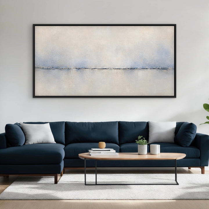 Calma Horizon panoramic blue abstract framed canvas above a navy sofa