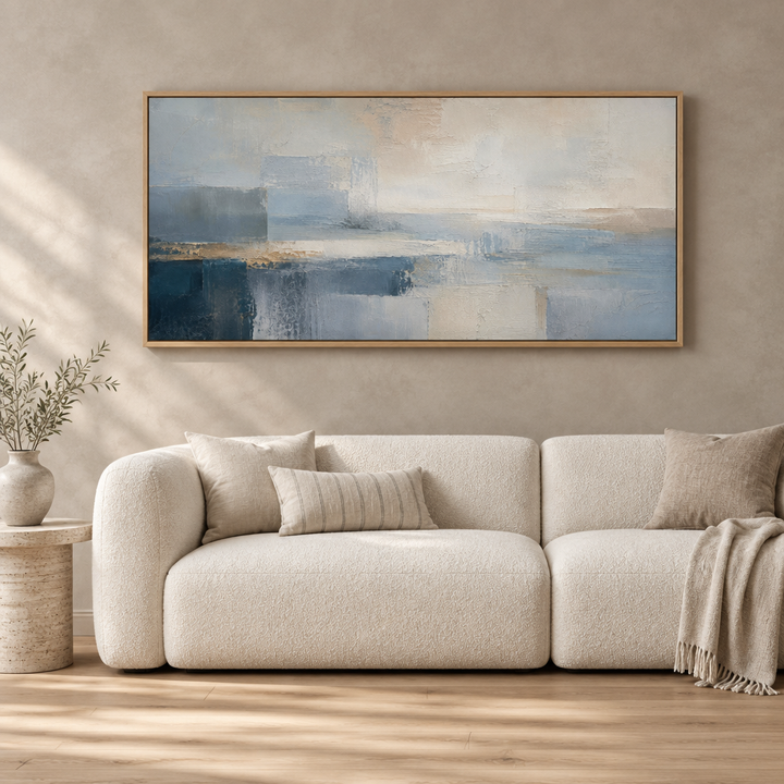 Corsica Blue panoramic framed canvas in a natural oak frame above a cream boucle sofa