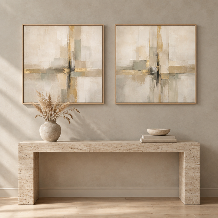 Quiet Gold set of two square framed canvases in natural oak frames above a travertine console