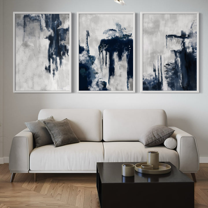Modern Abstract Art Styled With A Light Cream Sofa, Black Square Coffee Table, Grey Accent Pillows, And Wood Floors. Perfect For A Minimalist Living Room.