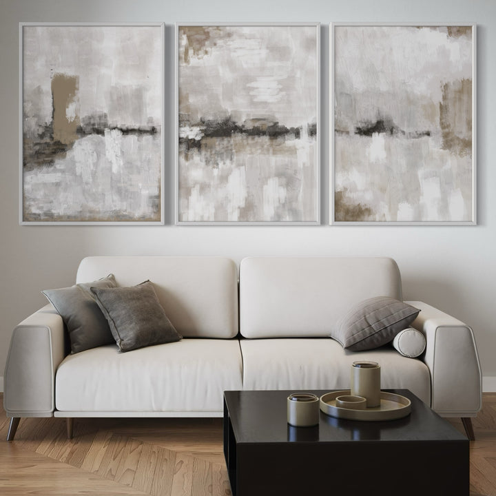 Modern Abstract Art Styled With A Light Cream Sofa, Black Square Coffee Table, Grey Accent Pillows, And Wood Floors. Perfect For A Minimalist Living Room.