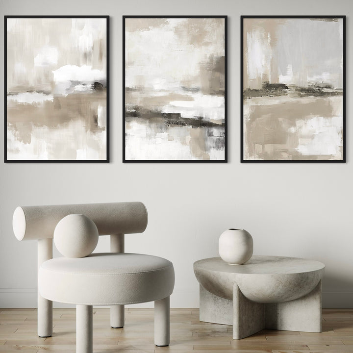 Set of 3 Framed Canvas Neutral Abstract Wall Art Prints in Sculptural Minimalist Space with Modern Accent Chair and Stone-Inspired Coffee Table
