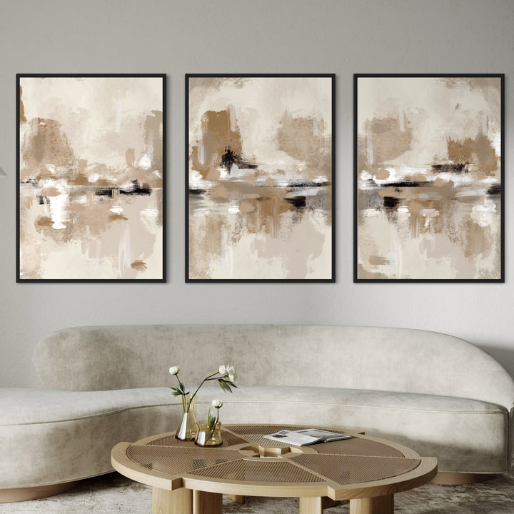 Elegant Abstract Canvas Wall Art Paired With a Curved Cream Sofa, Black Frames, and a Sculptural Round Wood Coffee Table with Brass Bud Vases- Elevates a Neutral Modern Living Room.