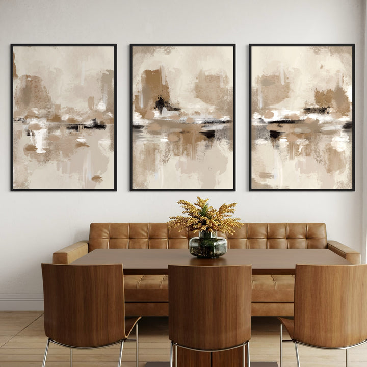 Modern Abstract Framed Canvas Wall Art Above a Caramel Leather Banquette And Walnut Dining Set, Styled With a Glass Vase Centerpiece For a Warm Modern Dining Room.