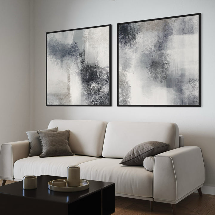 Abstract Canvas Wall Art With a Beige Sofa With Grey Cushions in a Modern Minimalist Living Room With a Black Coffee Table.