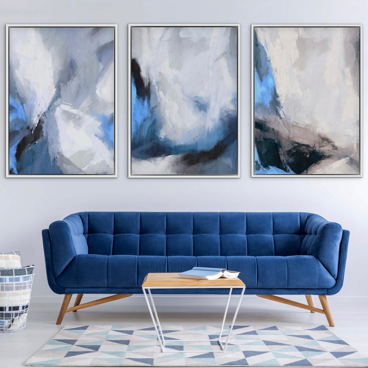 Modern Abstract Wall Art Styled With A Deep Blue Mid-Century Tufted Sofa, A Light Wood Coffee Table, A Geometric Pastel Rug, And A Minimal White Wall. Perfect For A Minimalist Living Room.