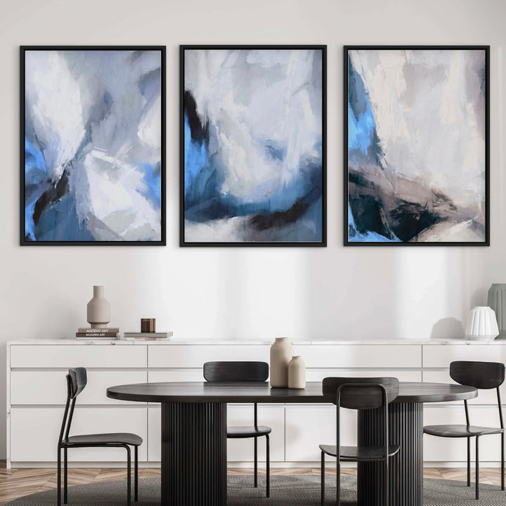 Modern Abstract Wall Art Styled With A Black Round Pedestal Dining Table, Four Black Metal Dining Chairs, A Clean White Sideboard, and Decorative Accent. Perfect For A Minimalist Dining Room Or Contemporary Kitchen Nook.
