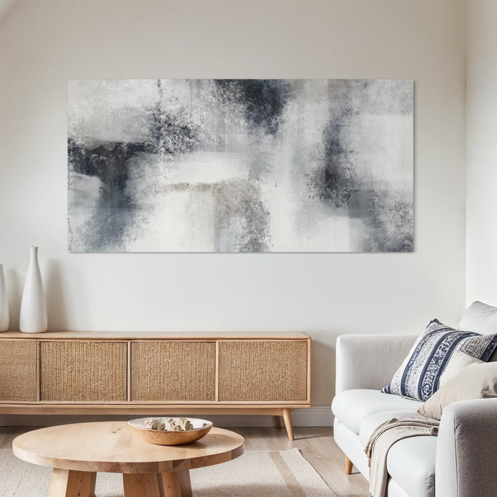 Large Minimalist Abstract Canvas Wall Art paired with a Light Gray Sofa, Rattan Wood Sideboard, Round Wood Coffee Table, and Neutral Decor in a Coastal Modern Living Room.