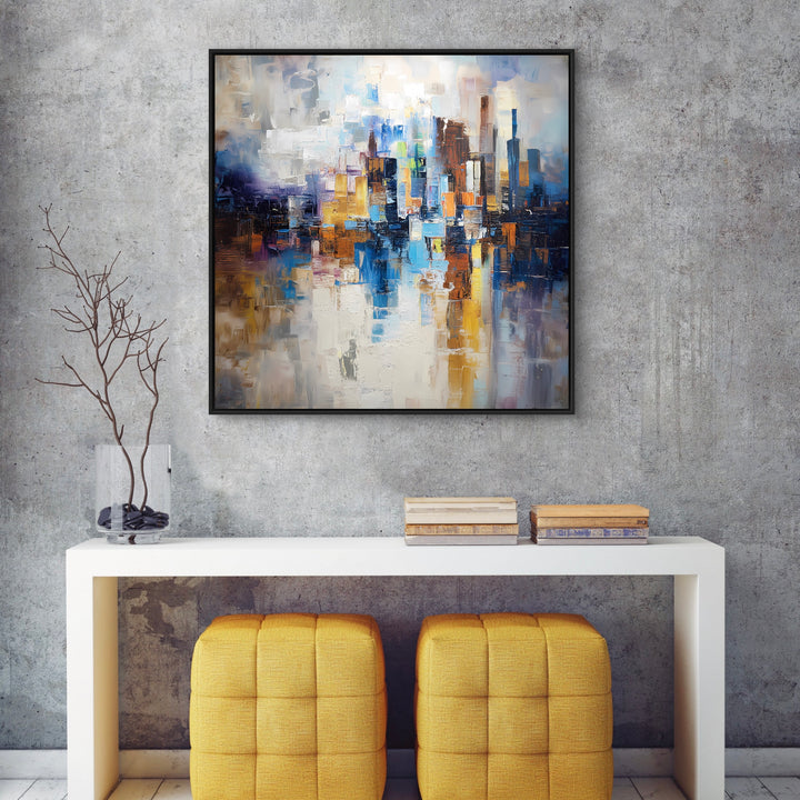  Framed Abstract Cityscape Canvas Wall Art in an Aesthetic Interior Corner with Gray Textured Concrete Background, White Console Table, Mustard Yellow Ottomans Chair and decorative Accent