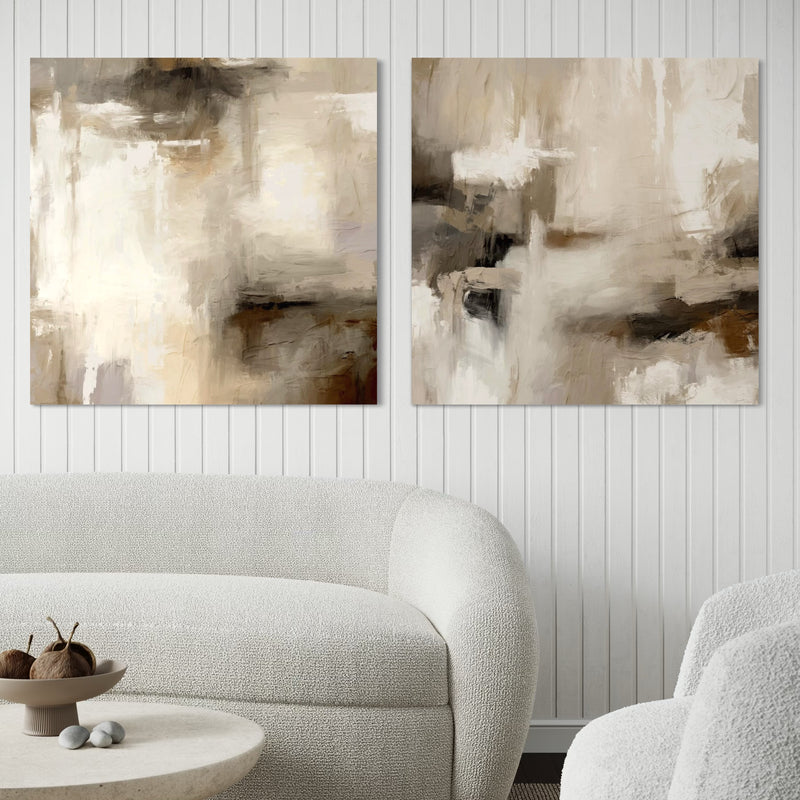 Neutral Abstract Canvas Wall Art With a Curved White Boucle Sofa in a Modern Minimalist Living Space With a Round Stone Coffee Table.
