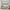 Neutral Abstract Framed Canvas Wall Art Above Textured Console Table and Patterned Accent Chair in Cozy Modern Living Room