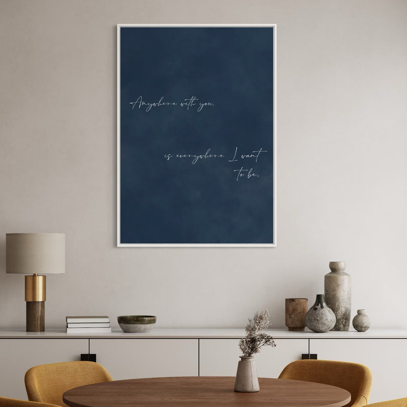 Navy Quote Canvas in a White Frame Styled with a Brass Lamp, Ceramic Vases, Round Wood Table, and Mustard Chairs, Elevate a Modern Dining Room with Minimalist Art.