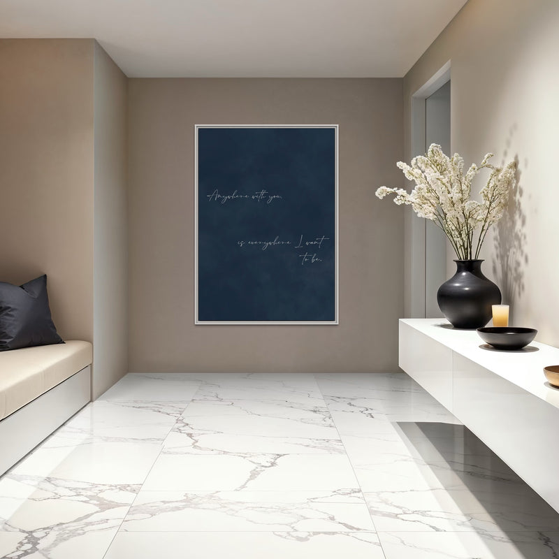 Navy Quote Canvas in a White Frame Styled With a Floating Console, Black Vase, and Marble Floors, Elevate Your Entryway with Minimalist Modern Wall Art.