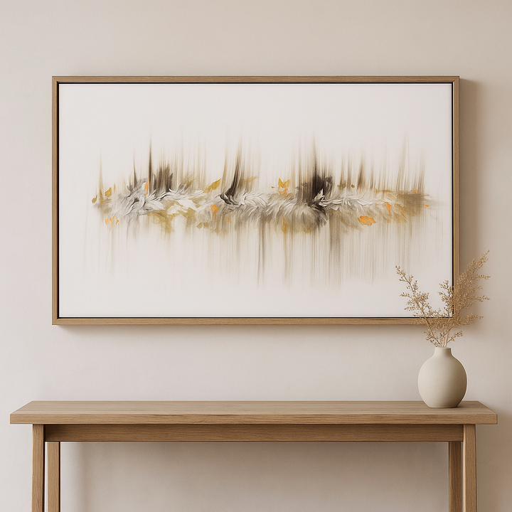 Framed abstract artwork on a wall above a wooden console table with a vase.