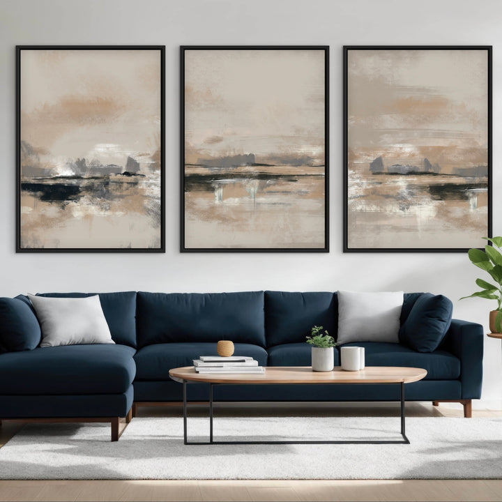 Rome beige and charcoal abstract triptych above a navy sectional sofa