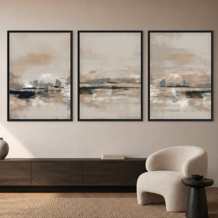Rome neutral abstract triptych above a dark wood sideboard and cream chair