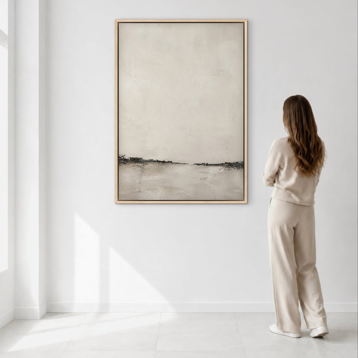 Nude Shore coastal neutral framed canvas above a console table