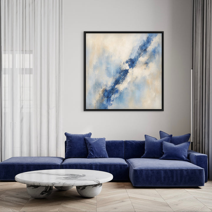 Lazuli blue abstract framed canvas above a navy sofa in a modern living room