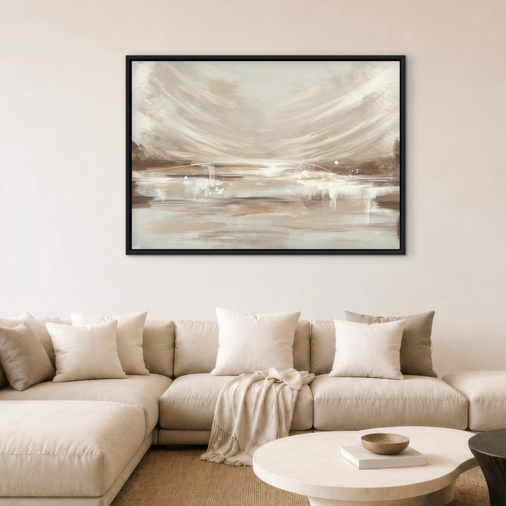 Vienna abstract framed canvas wall art in warm beige and taupe tones, black frame, hung above a cream sectional sofa