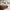 Minimalist Living Room Interior – Modern Abstract Framed Canvas Wall Art Above Brown Leather Sofa with Wooden Coffee Table and Neutral Rug