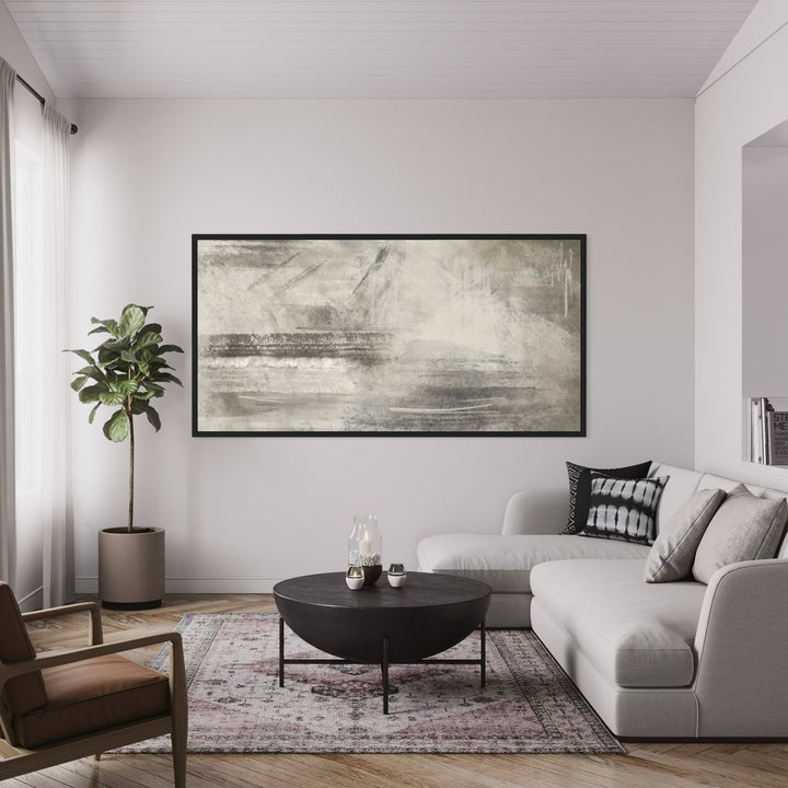 Wide Neutral Abstract Canvas Above a White Sectional With a Black Round Table and Vintage Rug—Serene Greige Wall Art to Elevate a Modern Living Room.