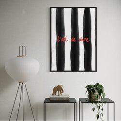 Stylish Abstract Framed Wall Art in Living Room with Minimalist Black Side Tables, Sculptural Decor, and Indoor Plant Accents