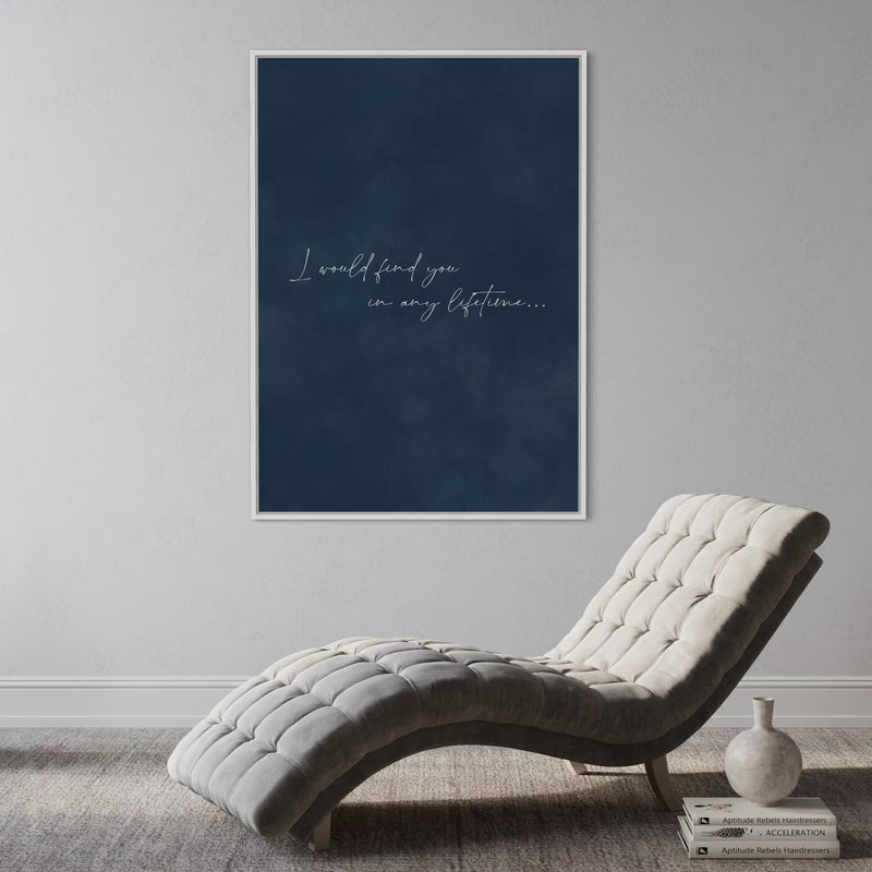 Navy Quote Canvas—“I would find you in any lifetime…”—Styled With a Tufted Grey Chaise, Books, And a Ceramic Vase For a Calm, Modern Reading Nook.