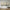 Modern Abstract Triptych Wall Art – Displayed in a Minimalist Space with a Mid-Century Armchair and Rustic Wood Flooring