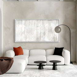 Modern Abstract Framed Canvas Wall Art – Living Room Decor with White Sectional Sofa, Black Center Tables, and Standing Lamp