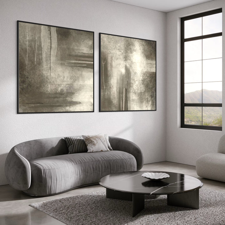 Neutral Abstract Diptych Above Grey Velvet and Boucle Sofas With a Black Round Table—Serene Greige Wall Art to Elevate a Modern Living Room.