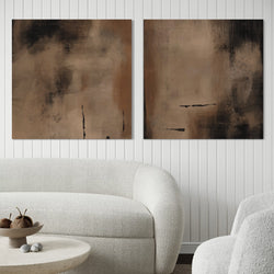 Set of Two Modern Abstract Canvas Wall Art Prints With White Boucle Sofa and Round Stone Coffee Table in Elegant Living Room.