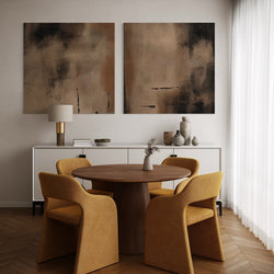 Set of Two Modern Abstract Canvas Wall Art Prints Above White Sideboard in Elegant Dining Room with Mustard Upholstered Chairs and Round Wood Table.