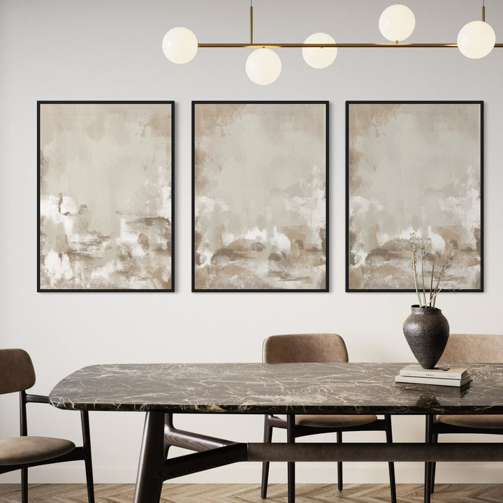Neutral Abstract Triptych Above a Marble Table and Brass Globe Chandelier- Sun-Washed Wall Art to Elevate a Modern Dining Room.