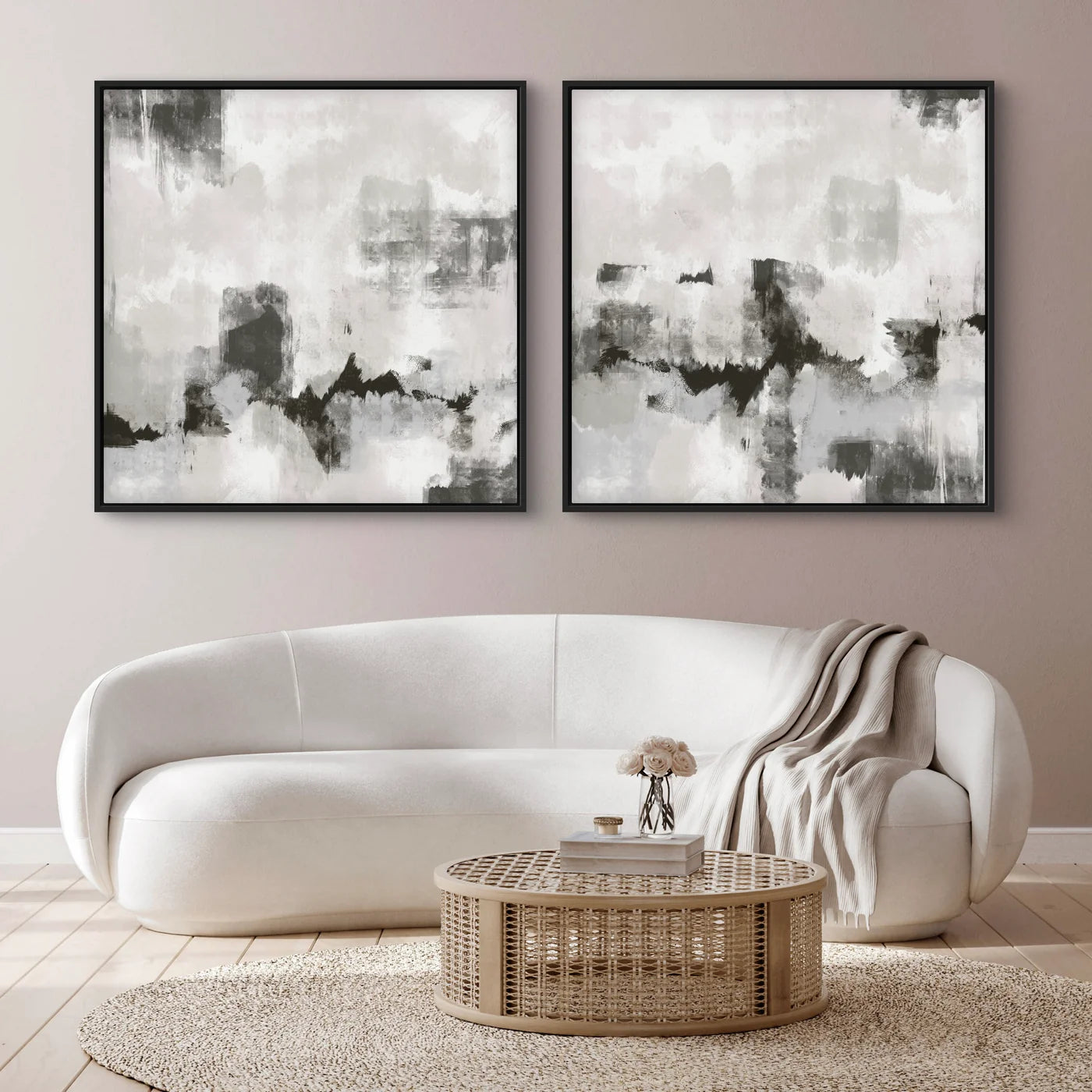 Abstract Wall Art Paired with a Curved White Sofa, Woven Rattan Round Coffee Table, Soft Neutral Throw, Blush-Greige Wall, and a Natural Jute Rug, Creating a Serene Modern Living Room Look.