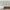 Set of 3 Abstract Framed Canvas Wall Art Prints Above Mid-Century Wood Sideboard with Decorative Accents and Upholstered Bench