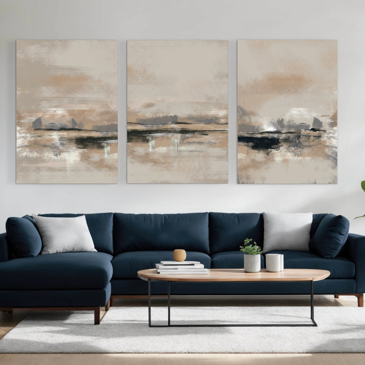 Modern Abstract Canvas Triptych Styled with a Navy Sectional Sofa, Light Wood Oval Coffee Table, and Soft Neutral Cushions on a White Rug. Perfect for a Minimalist Living Room.