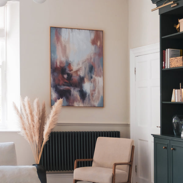 Modern Abstract Art Framed Canvas Styled with a Cream Lounge Chair, Pampas Grass Vase, and Dark Green Bookcase. Perfect for a Minimalist Living Room.