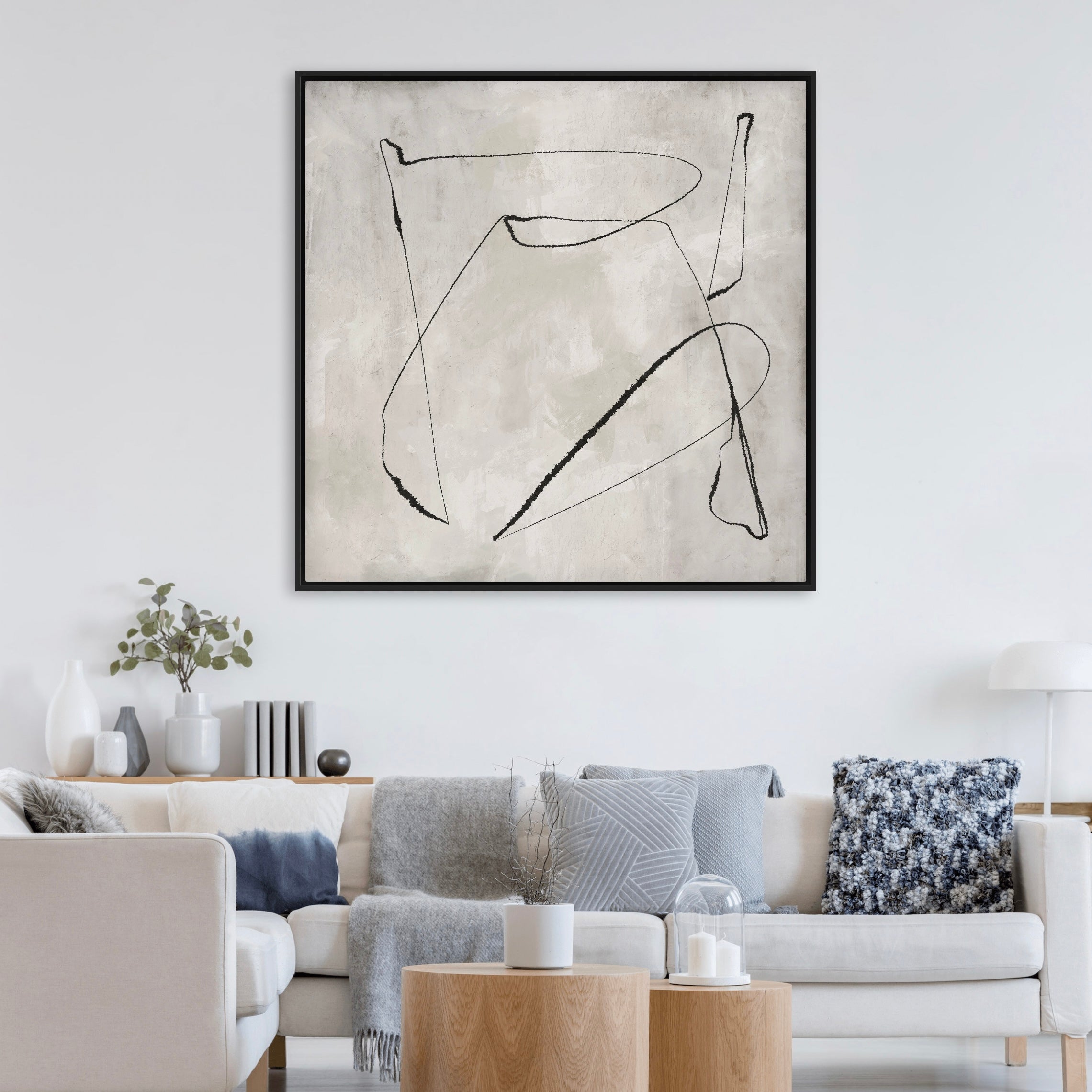 Modern Abstract  Framed Canvas Art Styled with a White Sectional Sofa, Round Wood Side Tables, Blue-Grey Pillows, and a Minimal White Table Lamp. Perfect for a Minimalist Living Room.