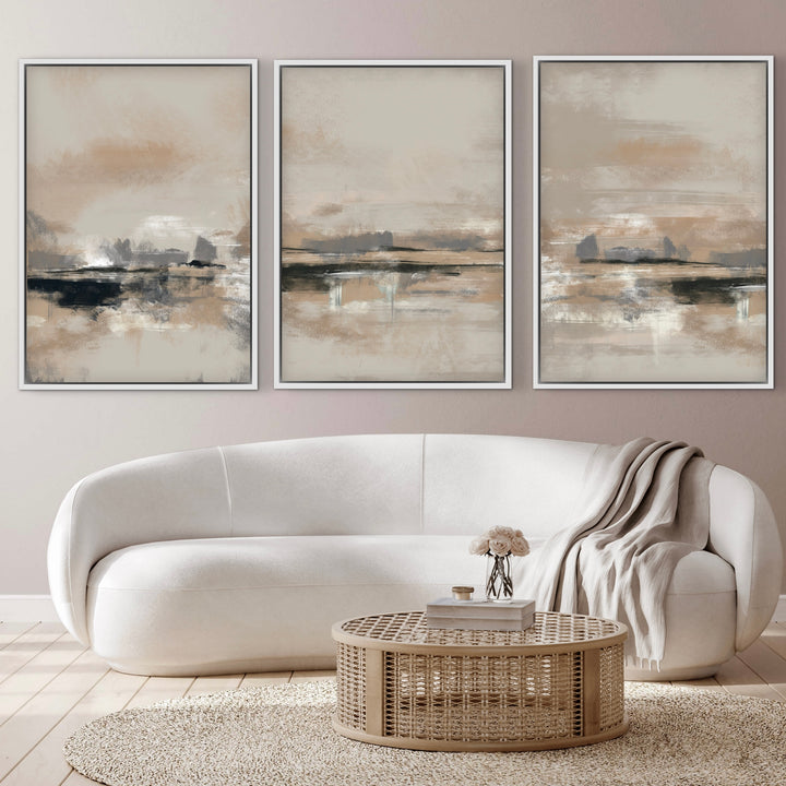 Modern Abstract Art Framed Canvas Triptych Styled with an Ivory Curved Sofa, Round Rattan Coffee Table, and Neutral Knit Throw. Perfect for a Minimalist Living Room.