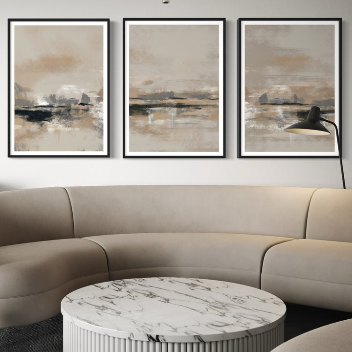 Modern Abstract Art Triptych Styled with a Curved Taupe Sectional, Round White Marble Fluted Coffee Table, and a Black Wall Lamp. Perfect for a Minimalist Living Room.