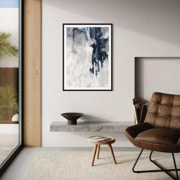 Modern living room with abstract art, brown chair, and wooden stool.