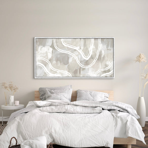 Elegant modern framed canvas wall art above the bed, complemented by flower vases on each bedside.