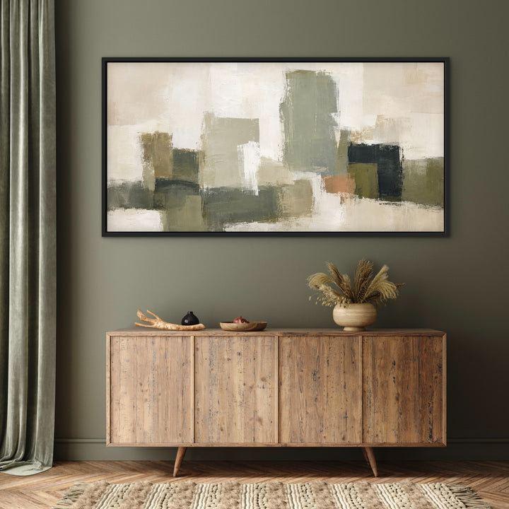 Atelier Blocks olive and neutral framed canvas above a wooden sideboard