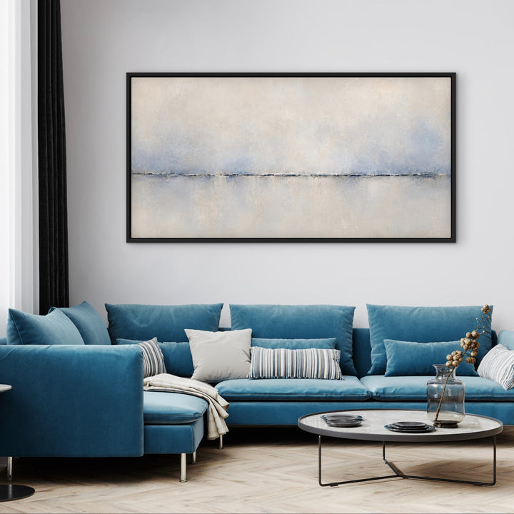 Calma Horizon panoramic blue abstract framed canvas above a blue sectional sofa