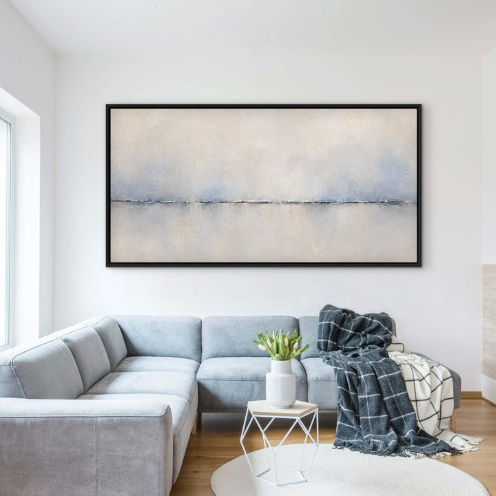 Calma Horizon panoramic blue abstract framed canvas above a grey sectional sofa
