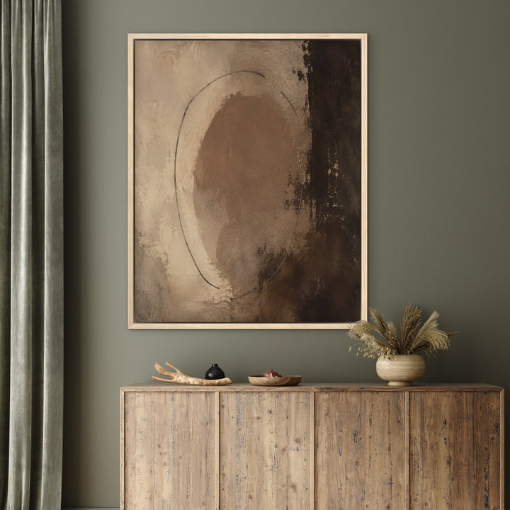 Chocolate Orbit brown abstract framed canvas on green wall, oak frame